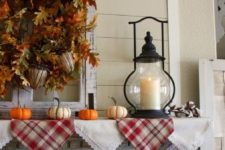 21 plaid and lace bunting, faux leaf and acorn wreath, small pumpkins and a candle lantern