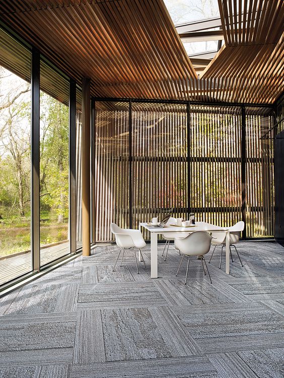 patterned carpet floors used for the open to outdoors dining area