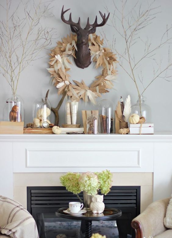feather wreath, pumpkins in cloches and vintage statuettes feather wreath, pumpkins in cloches and vintage statuettes