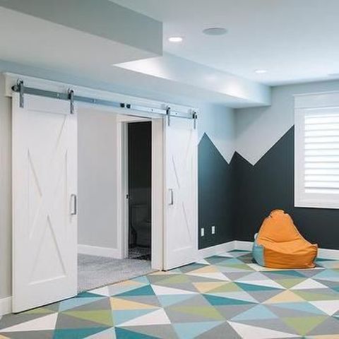 basement playroom with bold geometric carpet floors, which make falling not so hurt
