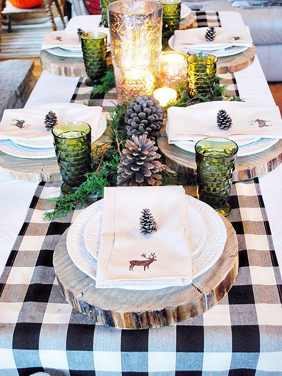 green glass candle holders, pinecones, wood slice chargers and greenery