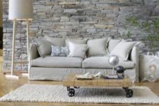 27 grey stone wall behind the sofa accentuates this area