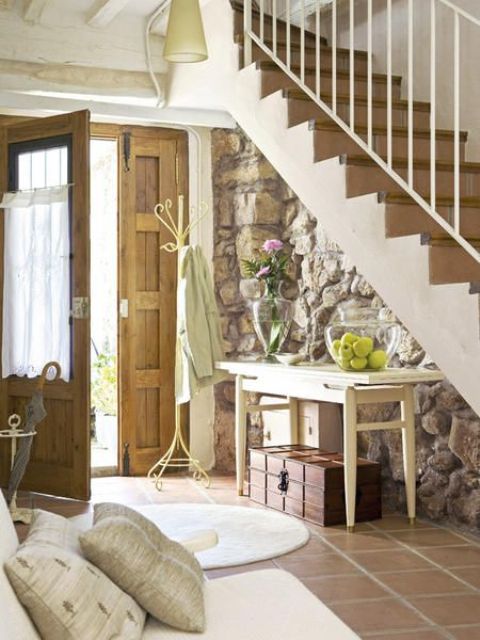 original stone clad was left to add a chic vintage look to the entryway