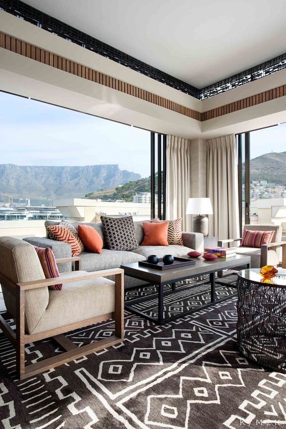 Textiles here create a mood and theme, warm-colored pillows and traditional tribal rugs scream Africa