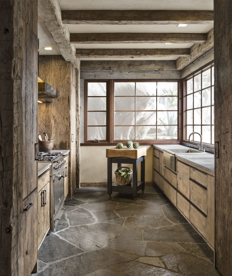 Rustic kitchen where even flooring looks rustic. (Studio Schicketanz)