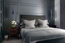 Floor to ceiling dark wainscoting makes this bedroom quite stylish and moody.