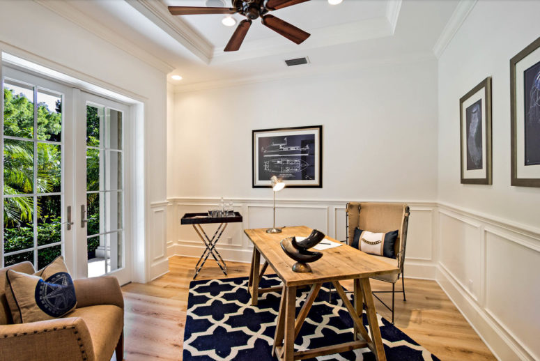 Wainscoting in this cozy home office make its plain white walls look interesting.