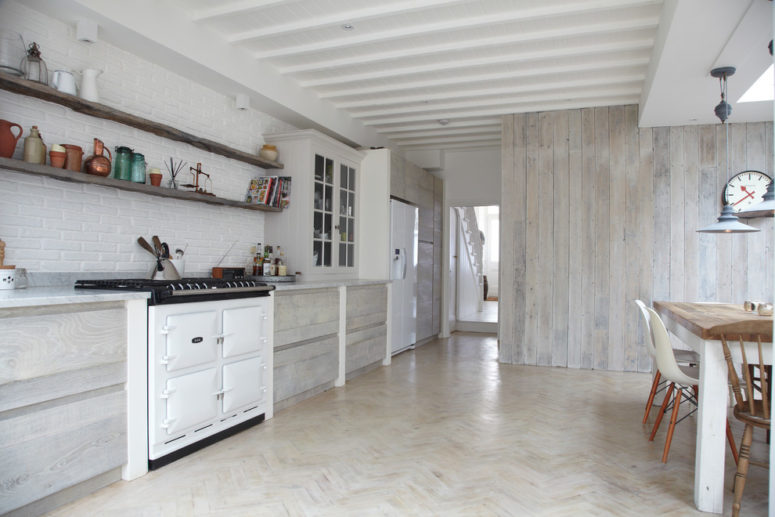 Whitewashed wood wall looks great on a kitchen when some cabinets feature whitewashed wooden doors. (Blakes London)