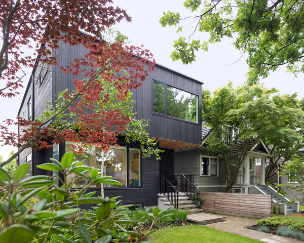 Modern House With A Black Exterior And Light Interiors