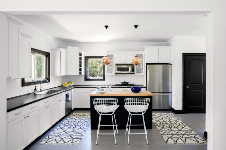 This modern beach home is decorated in white and framed with black details for a cool look