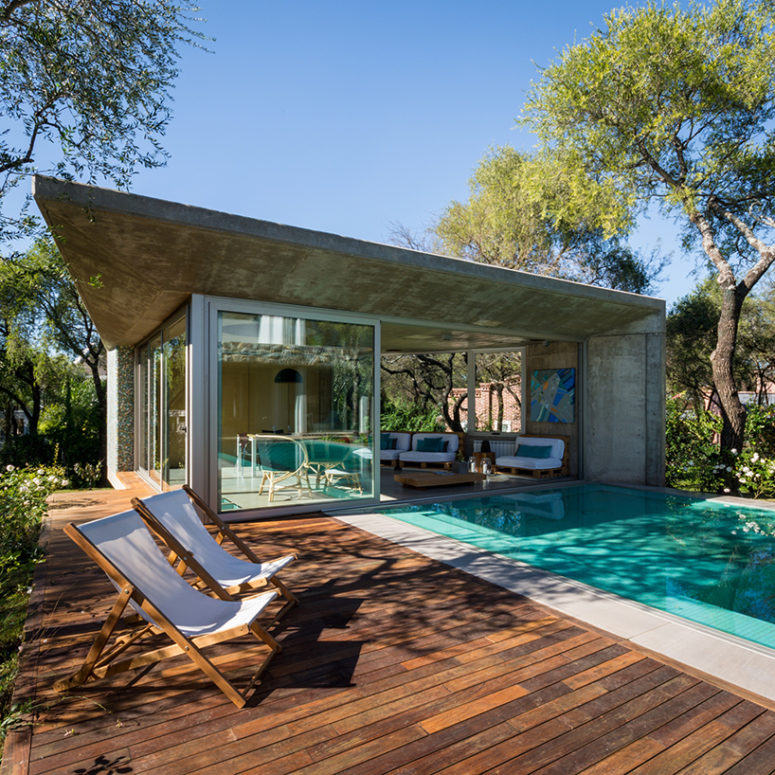 a separate concrete dwelling houses a fully equipped kitchen and grilling area