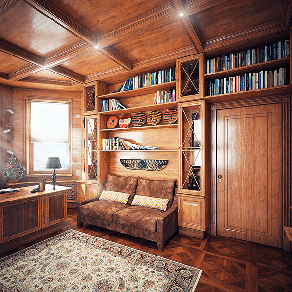 A small sofa is placed next to the desk in the built-in shelves