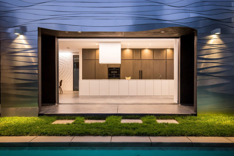 The kitchen is comprised of neutral-colored cabinets and a large white kitchen island