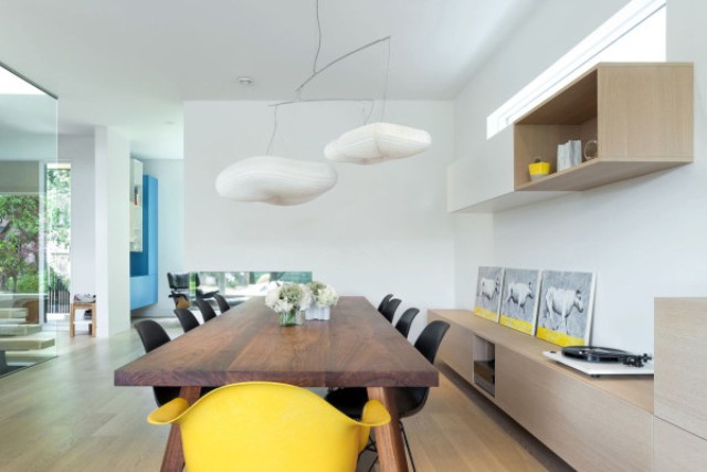 dining area The dining space is unique with its cloud lamps, rich-colored wooden table and sunny yellow accents
