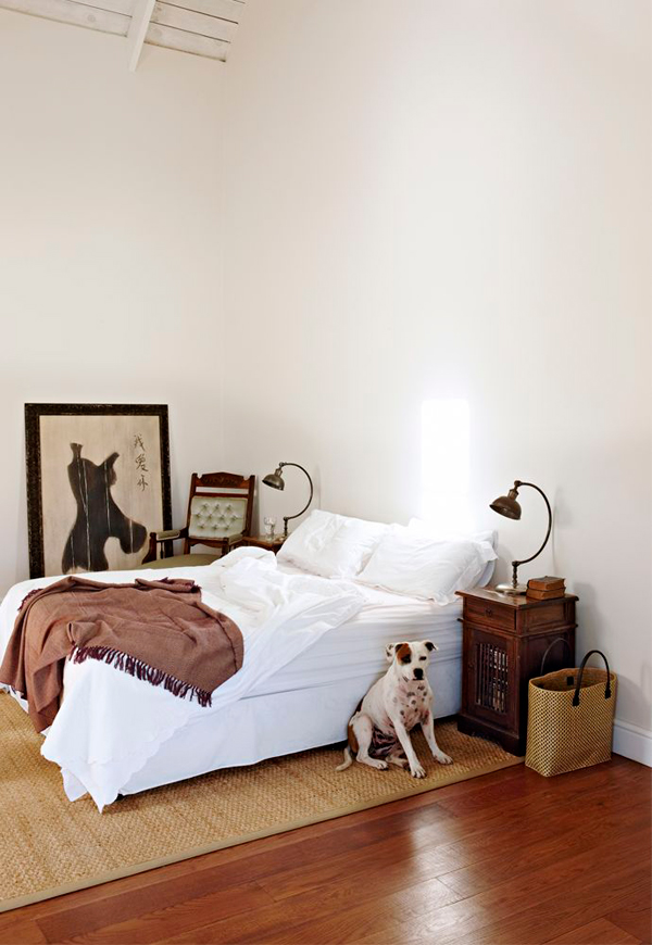 The master bedroom is very simple, with just a comfy bed, vintage nightstands and lamps and a jute rug for a textural look The master bedroom is very simple, with just a comfy bed, vintage nightstands and lamps and a jute rug for a textural look