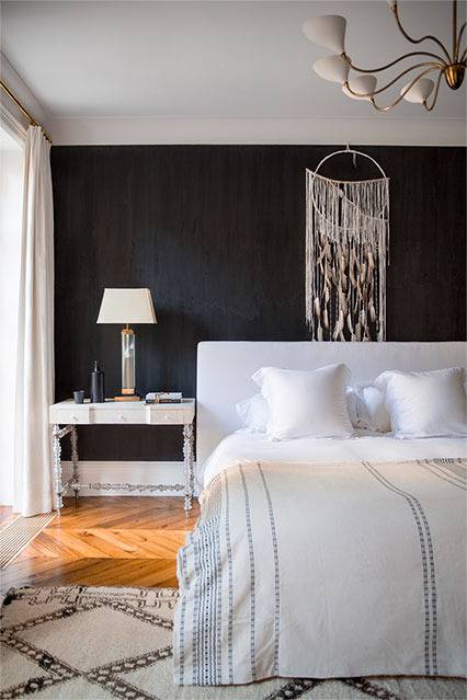 The master bedroom has a chalkboard headboard wall, a Moroccan rug and a dreamcatcher