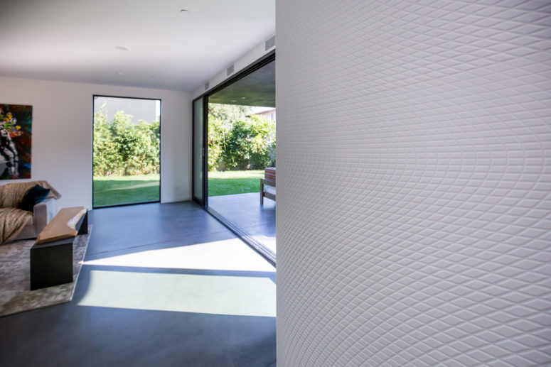 Inside walls and floors are covered with textural finishes that echo with the creative outer decor and architecture