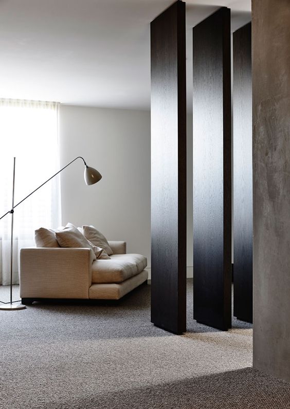 dark room divider Neutral colors and dark wood space dividers create a striking contrast and make up a cool space