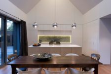 07 The kitchen is modern and minimalist, with a large glass door