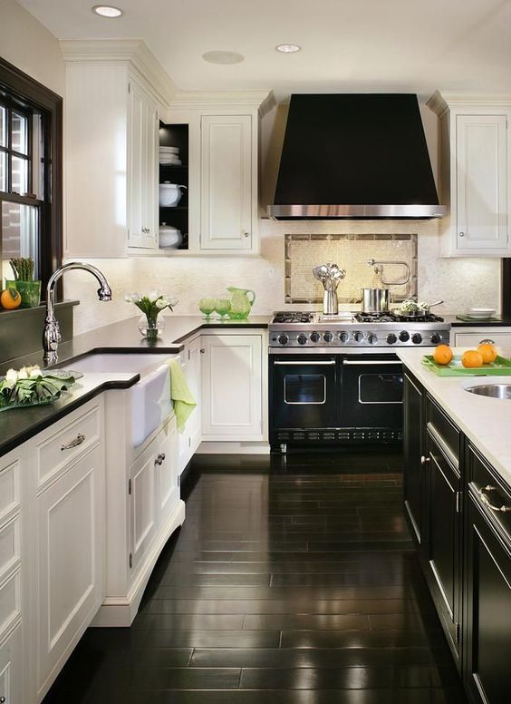 traditional and retro kitchen with a chic black cooker and hood
