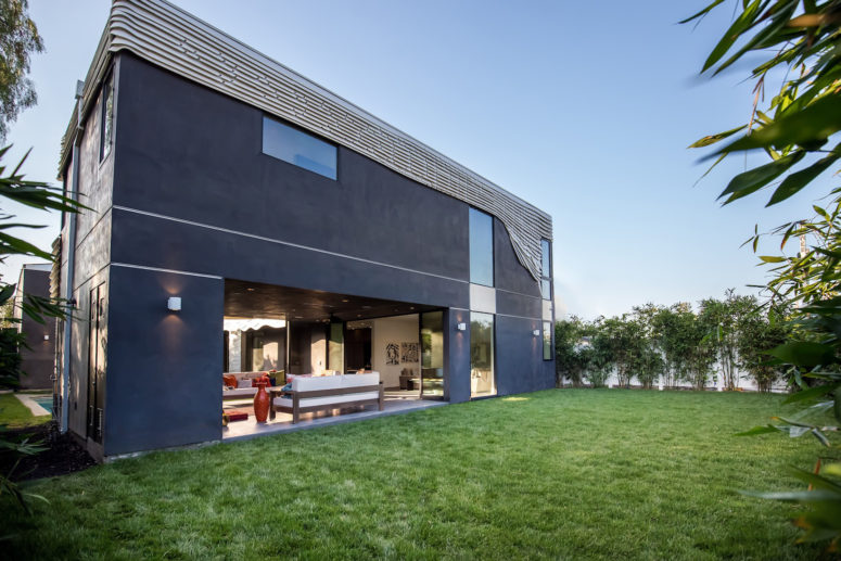 A large manicured lawn outside is a perfect space for relaxing and having picnics