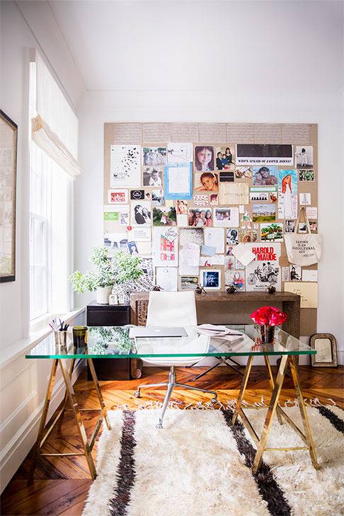 The home office is light and airy, there's a glass desk, a large memo board and a reading nook