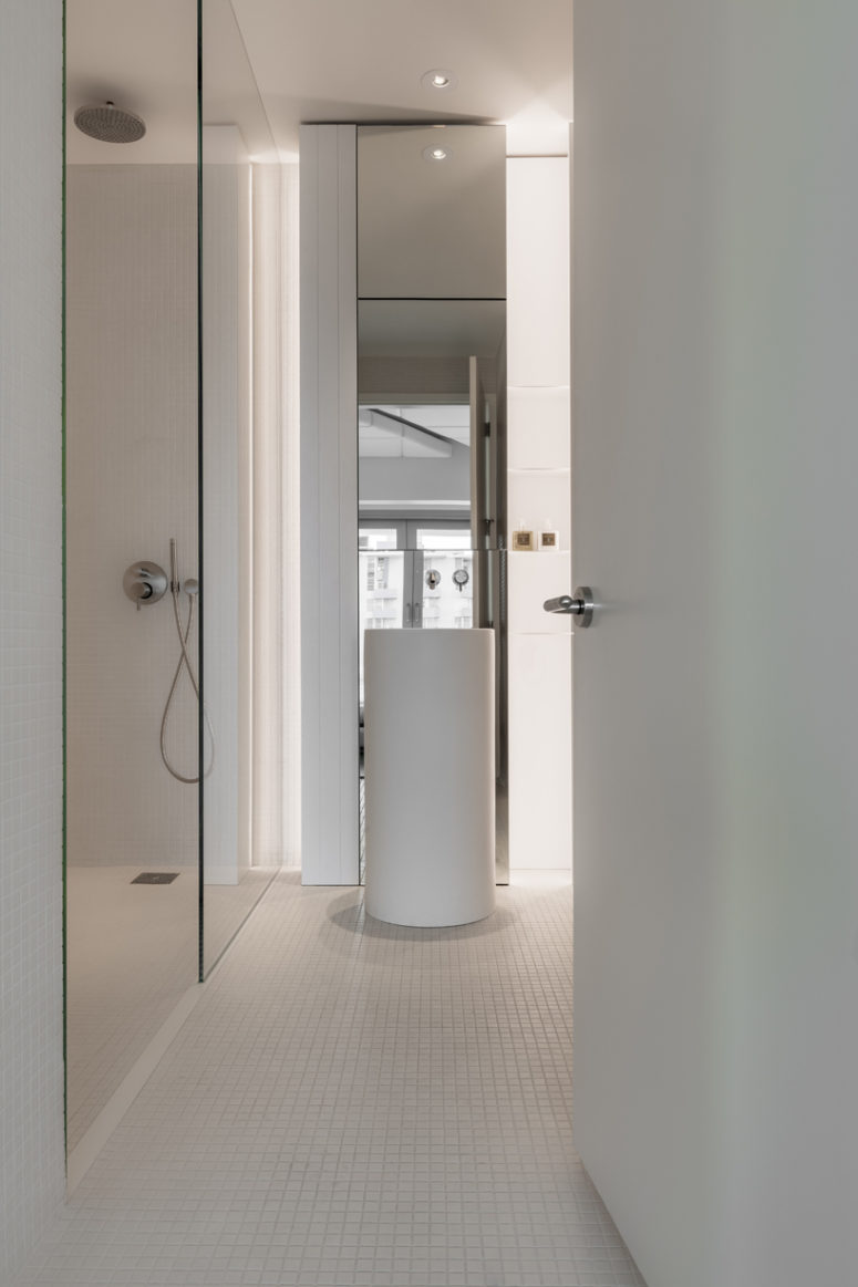 The master bathroom is decorated in minimalist white