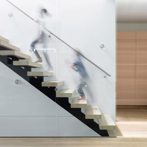 The staircase looks floating but it's totally safe because of glass panels, which also add a cool modern look