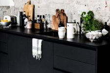 08 sleek black cabinets and vintage whitewashed wall leave an impression