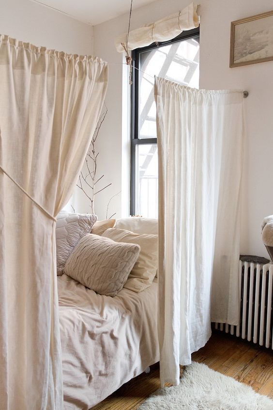 simple white curtains separate the comfy sleeping space making it more relaxing