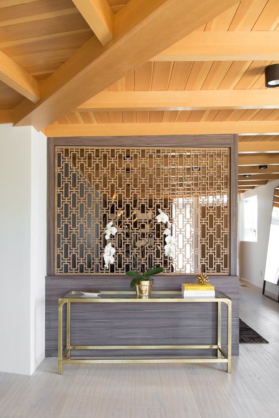 stylish art deco screen to separate the entryway from the rest of the space