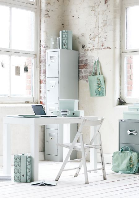 airy and light home office with uneven brick walls and aqua accents