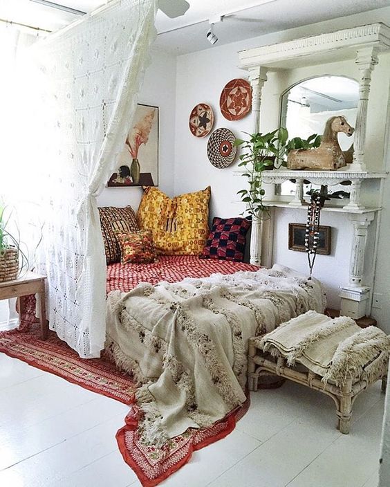 this crochet curtain not only sections off the sleeping space but also adds to its boho decor