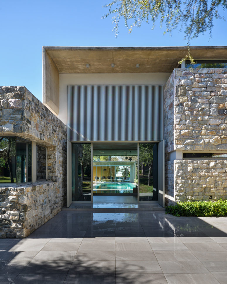 modern entrance clad with natural stone and sleek tiles for a contrast