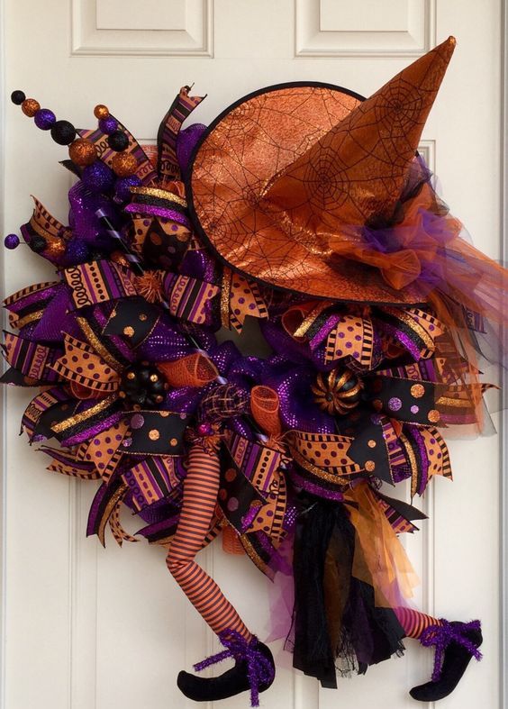 bold purple and orange wreath with a witch hat and legs