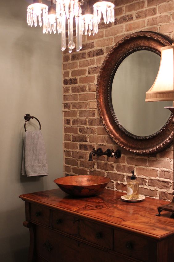 vintage bathroom decor is highlighted with a brick wall