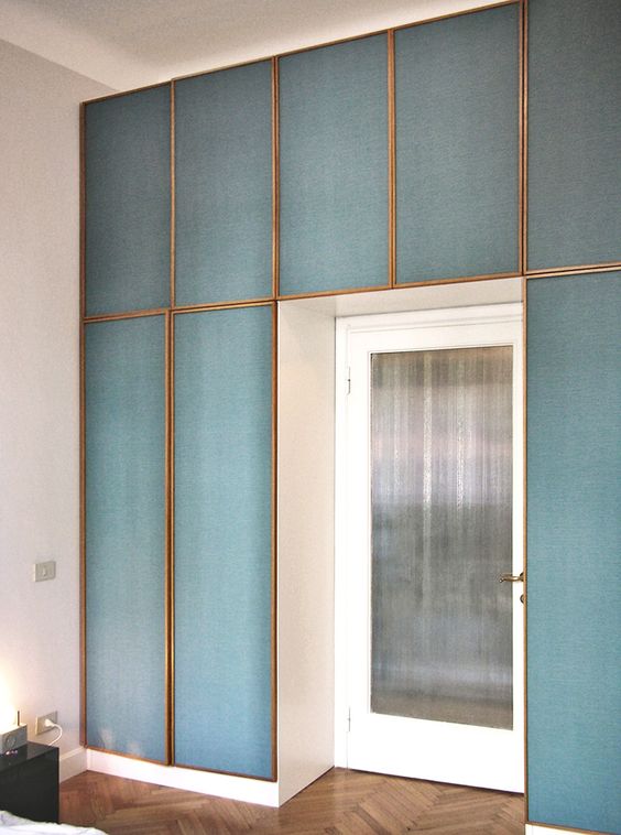 framed blue fabric panels accentuate the entrance to the room