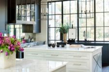 15 airy kitchen with two white kitchen islands and a large black framed window