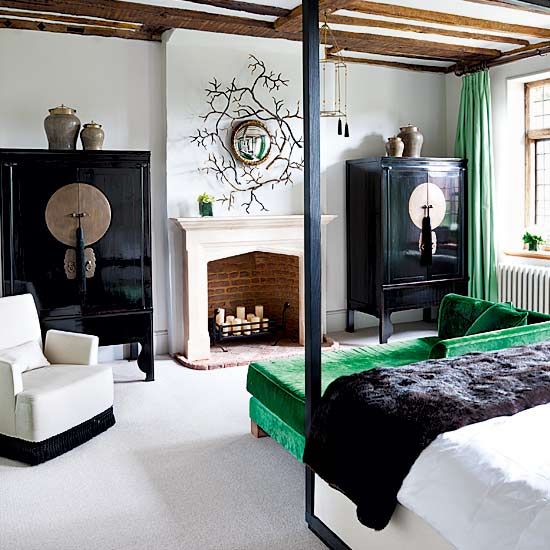 polished black cabinets and emerald textiles to spruce the bedroom