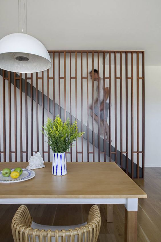 modern wooden screen to cover the staircase and make the dining area cozier