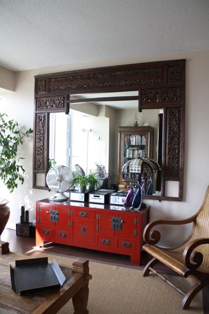 red oriental console table looks cool with an Indian frame mirror