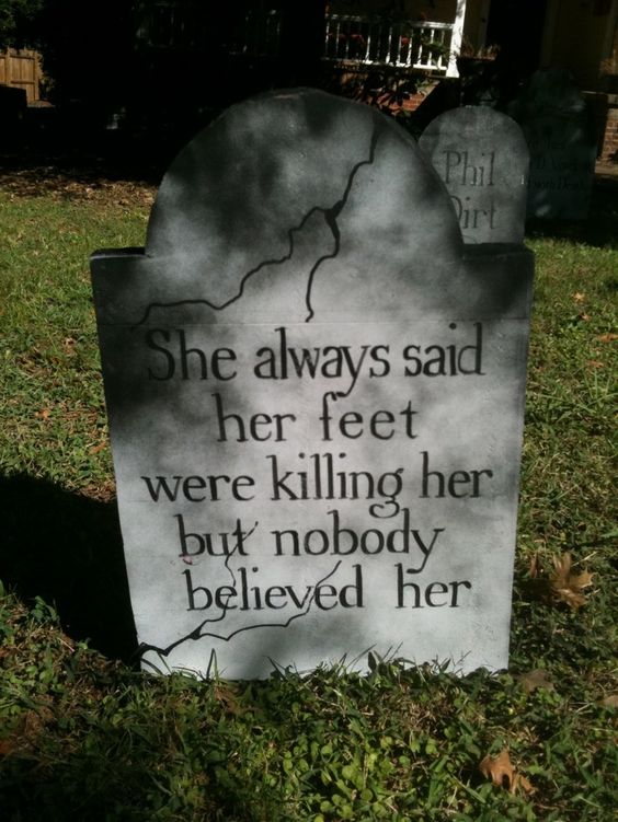 tombstones on bottom cabinet doors, each one with a funny name and epitaph