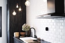 16 white subway tiles and black wooden cabinets give this kitchen a textural look