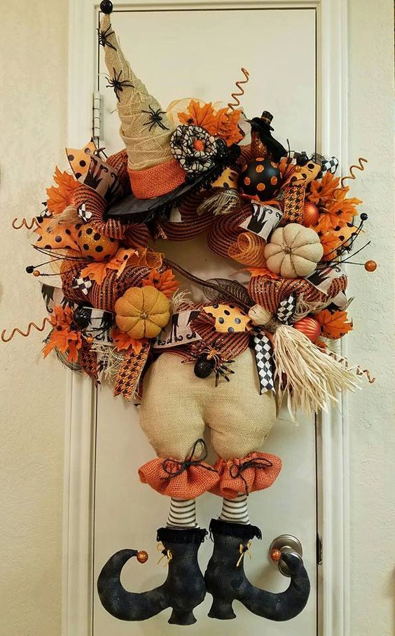 orange witch wreath with spiders, pumpkins and brooms