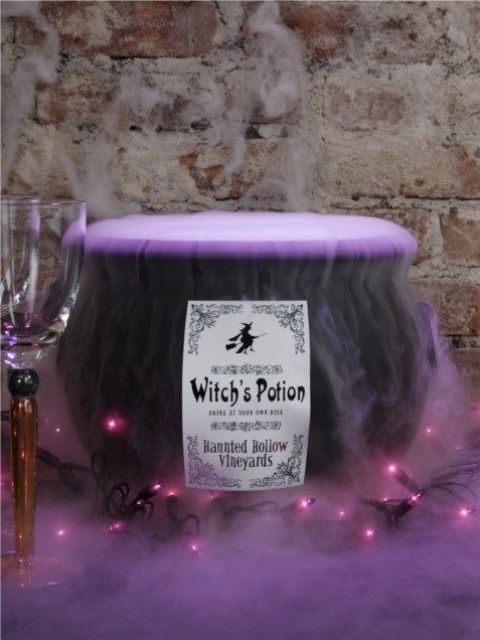 cauldron with purple fog potion and lights for Halloween decor