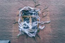20 give your home a ghoulish look with faux spiderweb, branches and spiders