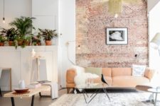 20 the sitting zone is accentuated with a brick wall behind the sofa