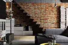 21 a brick wall makes the staircase stand out in this industrial space