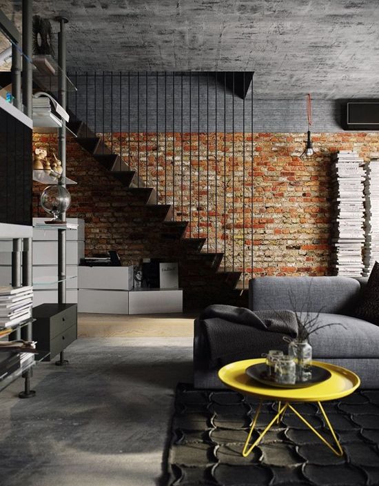 a brick wall makes the staircase stand out in this industrial space