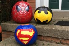 21 painted Batman, Superman and Spiderman pumpkins for outdoor decor